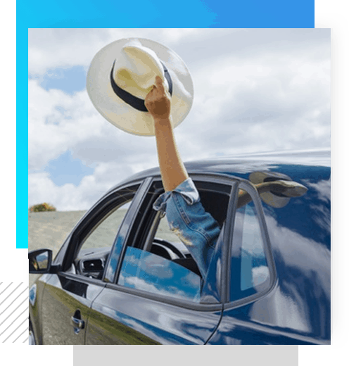 woman hanging her hat out of a tinted car window