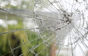 Old cracked dirty broken glass window background.