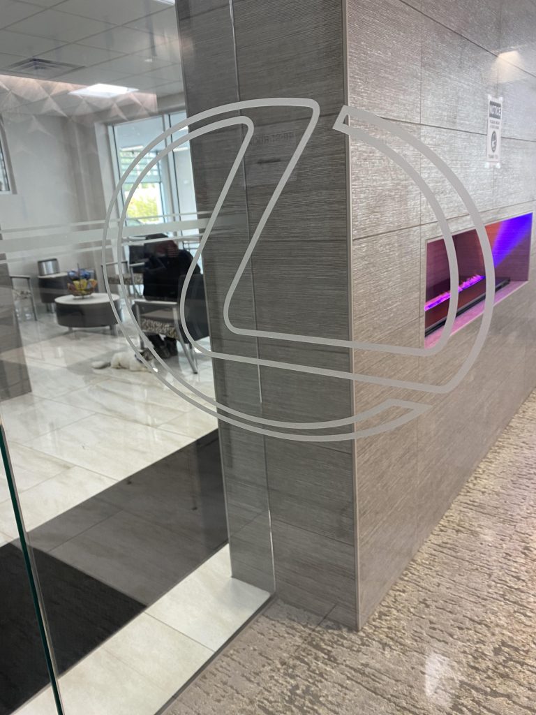 Decorative Window Film is used to create a custom logo at an auto dealership in Owings Mills, Maryland