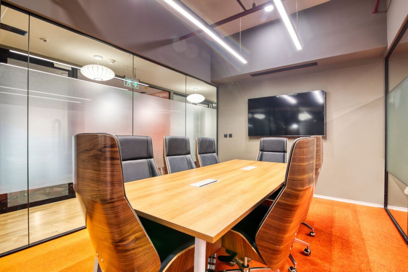 Conference room with floor-to-ceiling glass walls, the kind of space where switchable smart film adds privacy on demand
